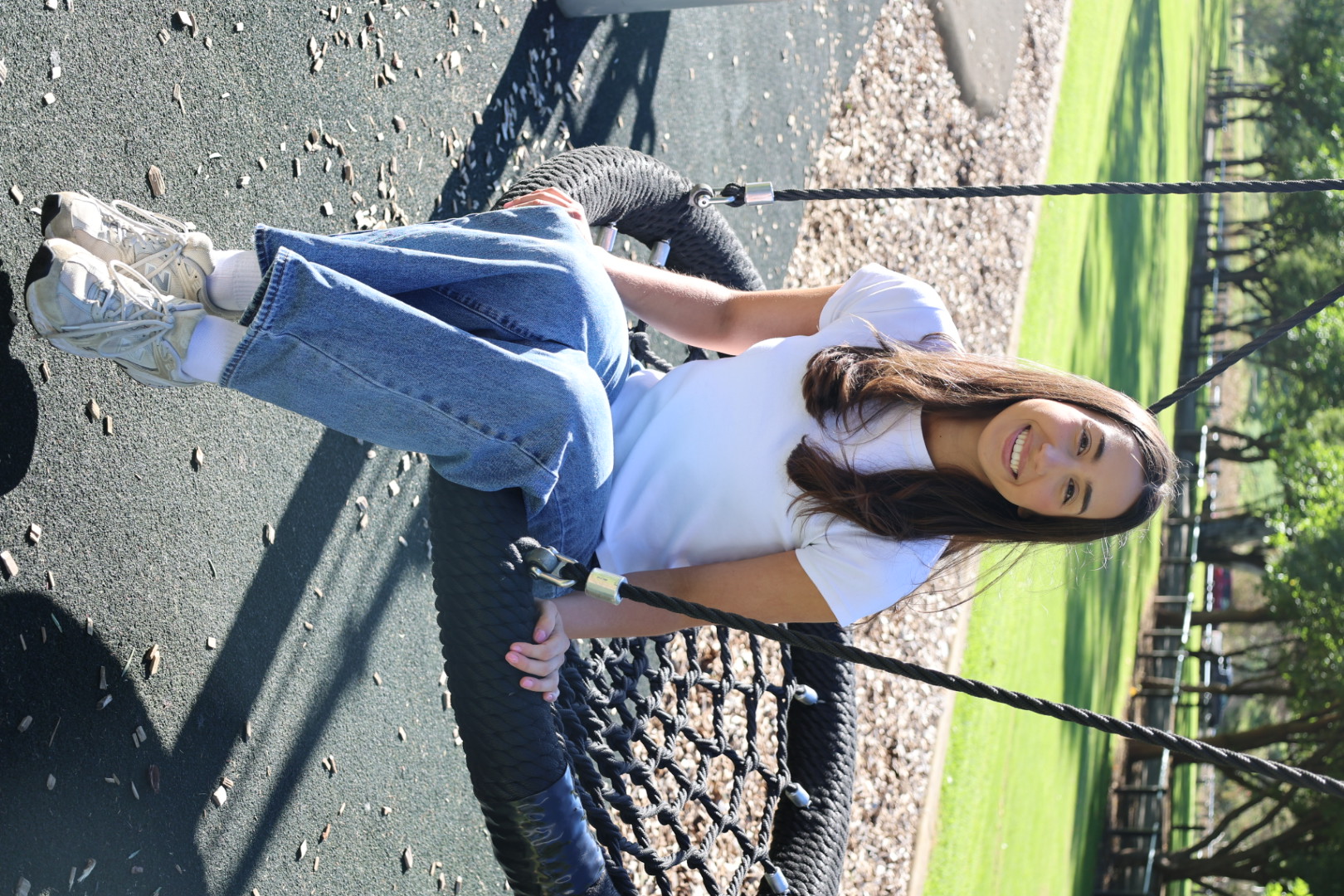 Tamsyn sitting on a nest swing at a local park